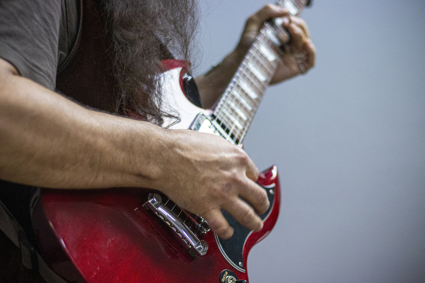 Person playing a red guitar